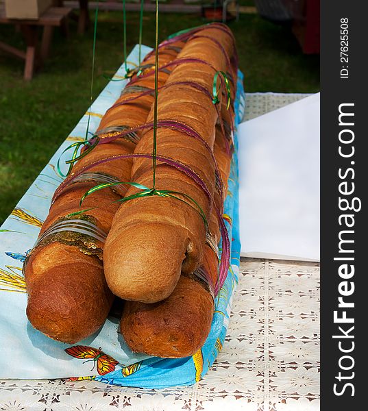 Big long bread on the table at the kirn outdoor. Big long bread on the table at the kirn outdoor
