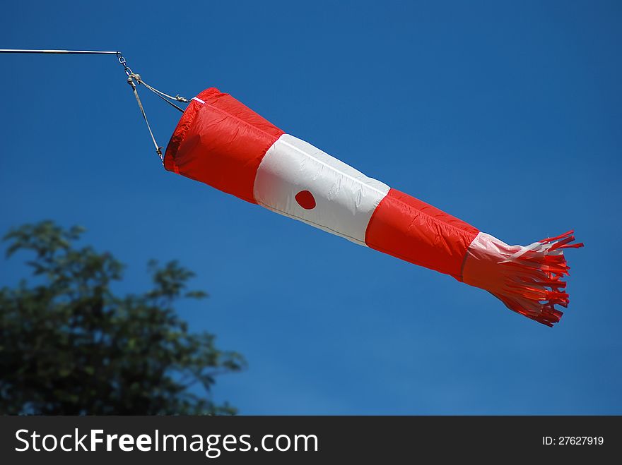 Wind indicator at the airport with blue sky in the background