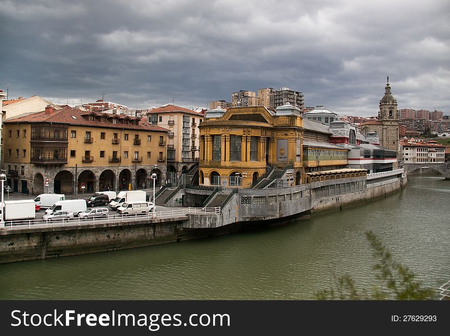 Bilbaos Mercado de La Rivera picture in a cloudy day with the old town at the background. Bilbaos Mercado de La Rivera picture in a cloudy day with the old town at the background.