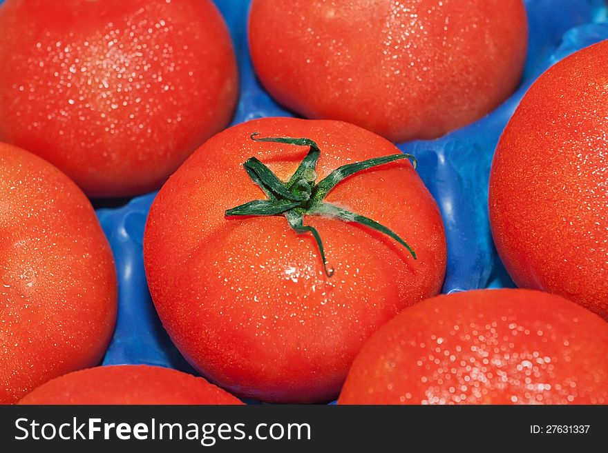 Tomatoes in a box close up. Tomatoes in a box close up.