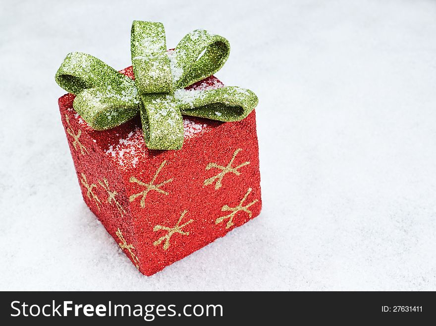 Christmas gift box with a bow on snow. Christmas gift box with a bow on snow.