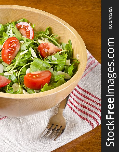 A bowl of Arugula salad with tomatoes and shaved almonds #2. A bowl of Arugula salad with tomatoes and shaved almonds #2