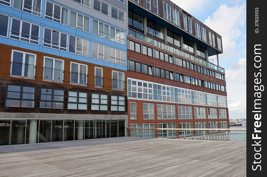 This image presents a modern apartments building in Amsterdam, Holland, near the water