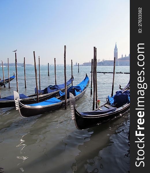 Gondolas parked on a Venetian water canal