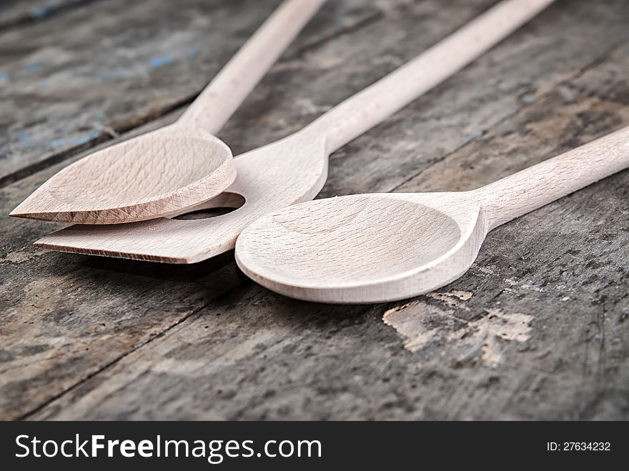 Wooden spoons on old retro wooden background