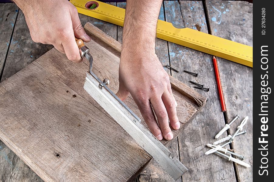 Carpenter Working On A Hand Saw