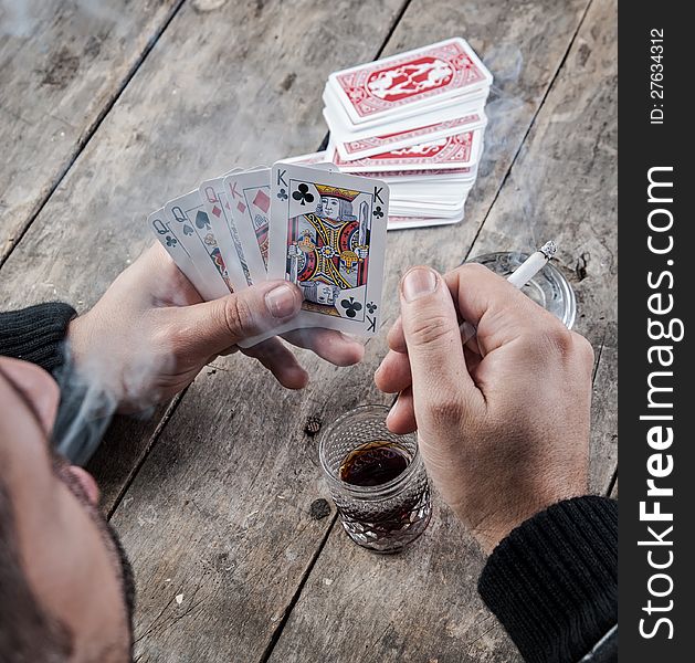 Man holding A Poker Hand Full House