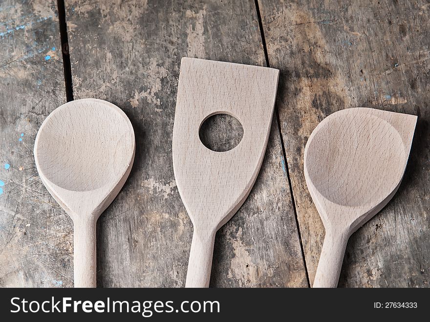 Wooden spoons on old retro wooden background