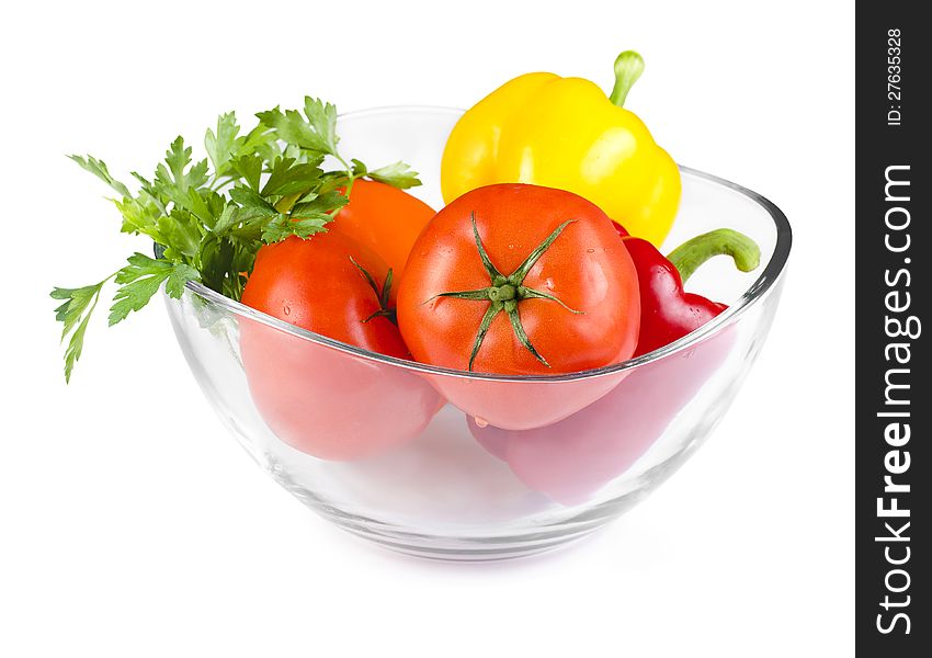 Fresh colorful vegetables in a oval glass bowl  on white. Fresh colorful vegetables in a oval glass bowl  on white