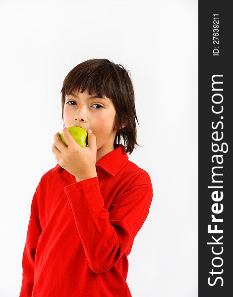 Boy eating a green apple isolated on white background