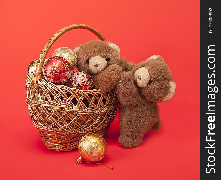 Teddy Bears and a basket with Christmas toys.