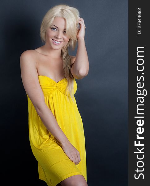 An image of a beautiful woman in a yellow dress. An image of a beautiful woman in a yellow dress