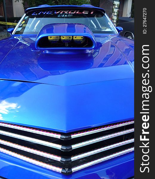 Front grill view of a blue car with air scoop. Front grill view of a blue car with air scoop