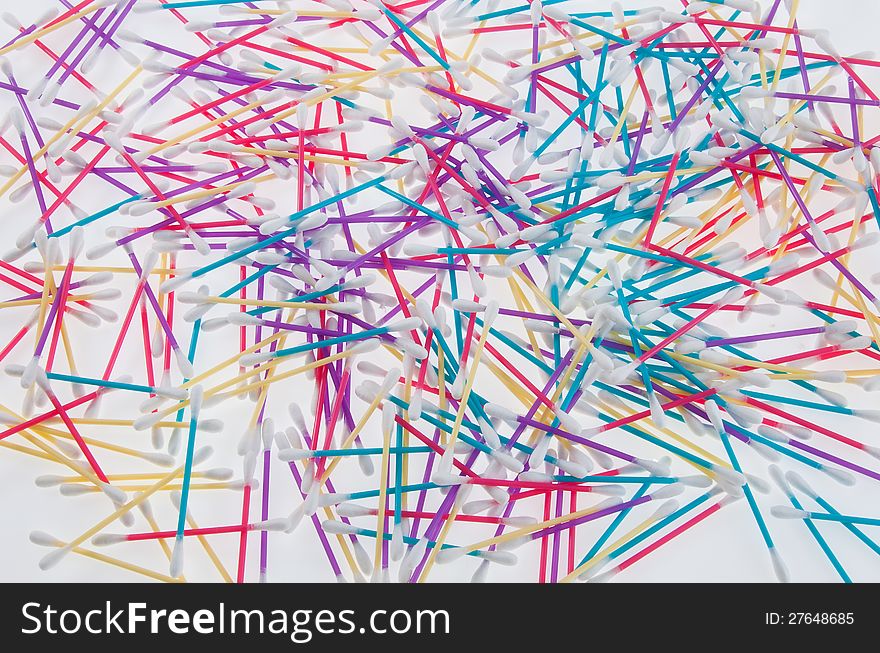 Mixed colors of q-tips on white table. Mixed colors of q-tips on white table