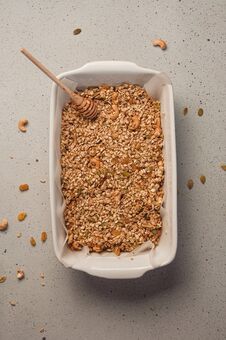 Homemade Granola Cooking Process - Oat, Cashew Nuts, Raisins And Pumpkin Seeds In Baking Dish. Healthy Breakfast Concept. Top View Stock Image