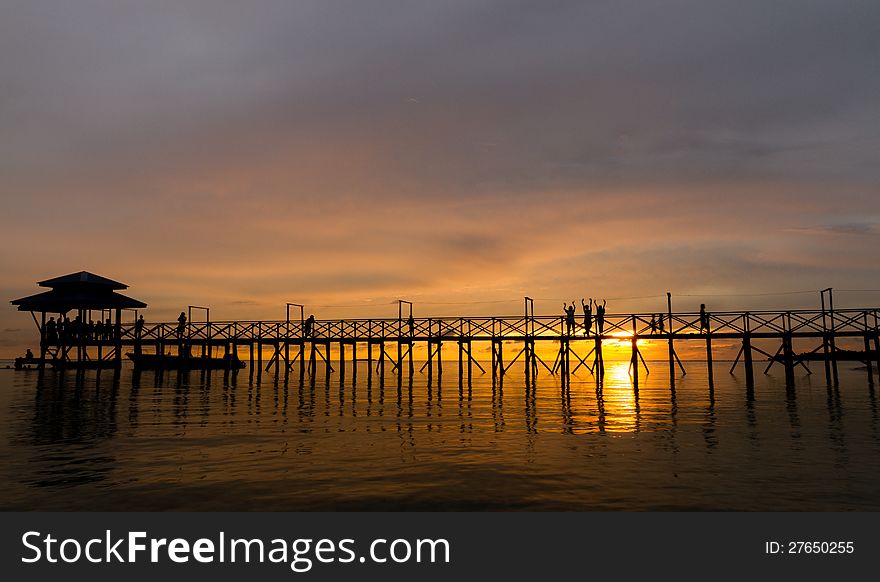 Bridge on beach in sunset