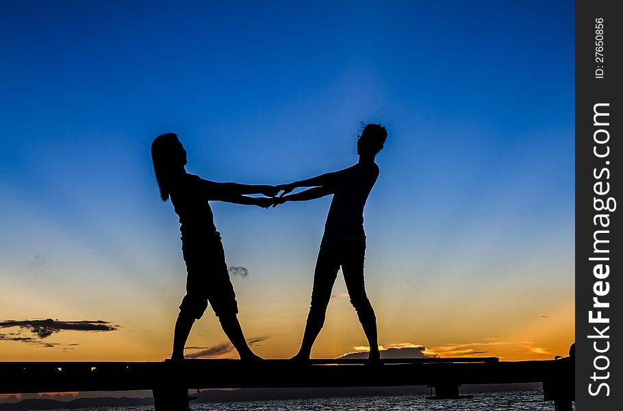 Girls standing on Bridge at Sunrise in Thailand