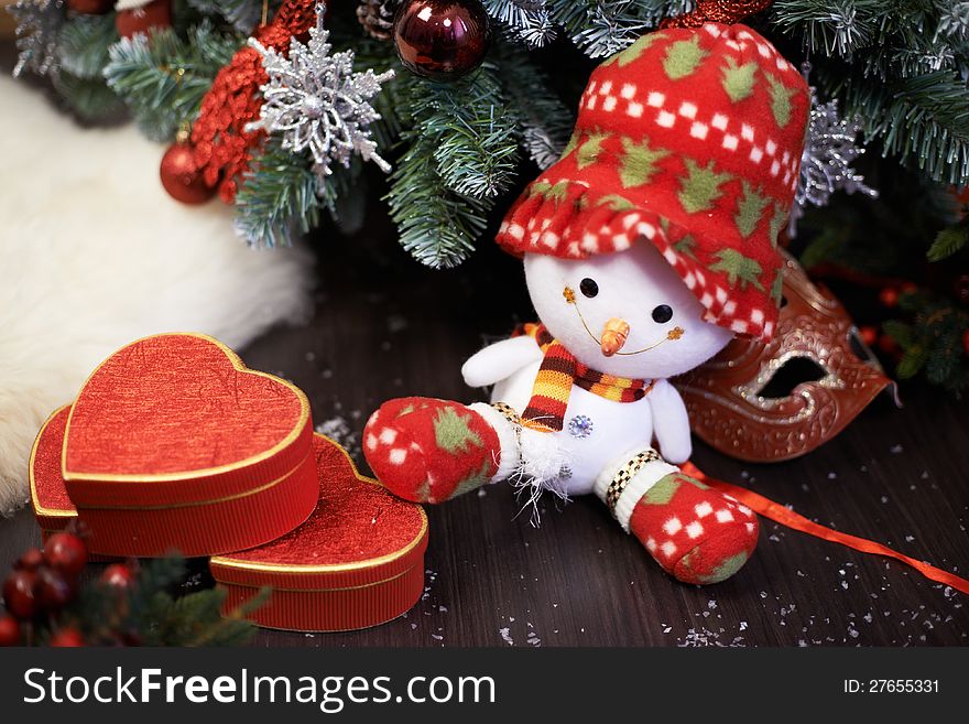 Snowman and gifts under christmas tree