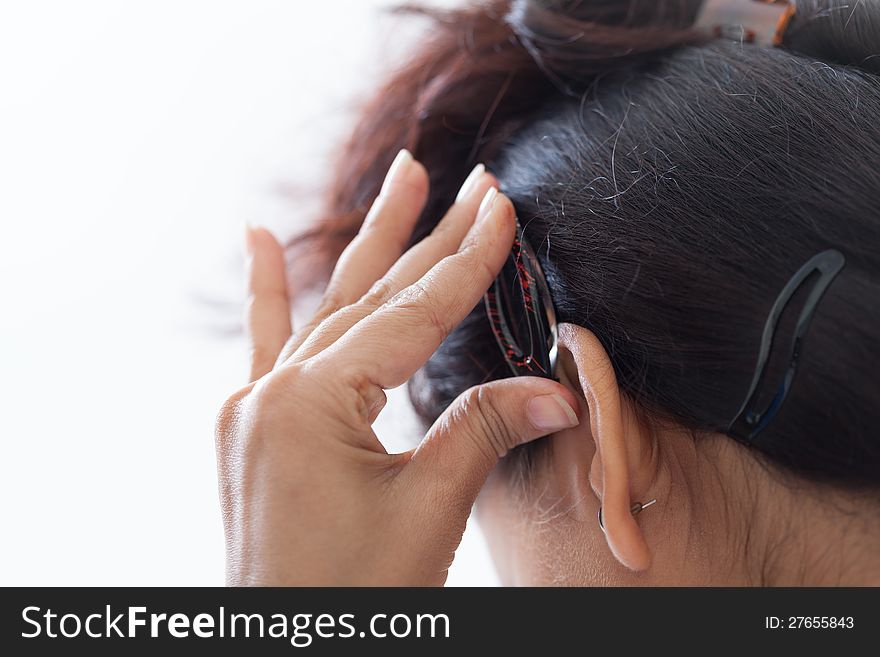 Self making of hairstyle using clip by indian girl isolated over white. Self making of hairstyle using clip by indian girl isolated over white