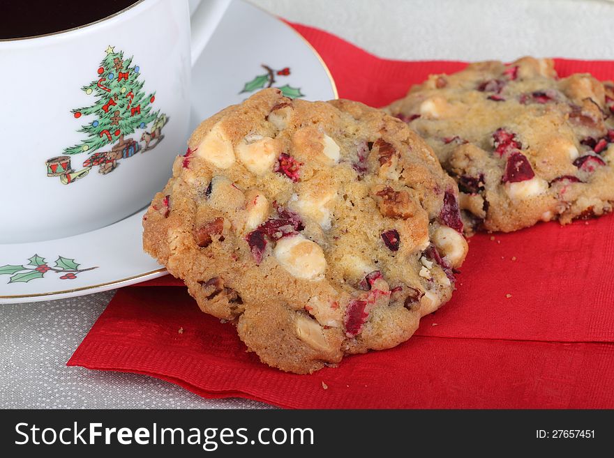 Closeup of two cranberry and nut cookies and cup of coffee. Closeup of two cranberry and nut cookies and cup of coffee