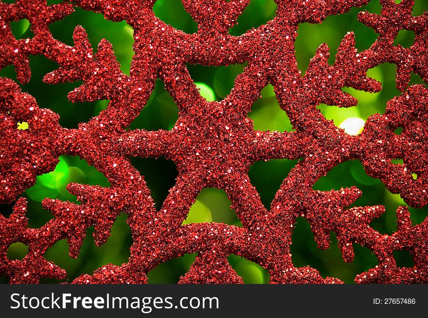 Red Snowflake On Green Blurred Background