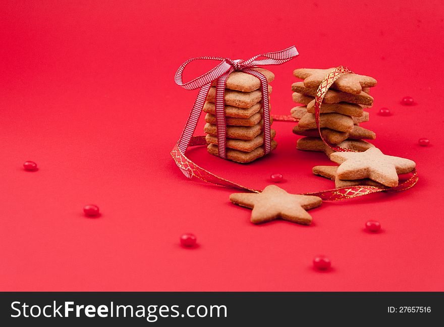 Sugar cookies with ribbons on red background