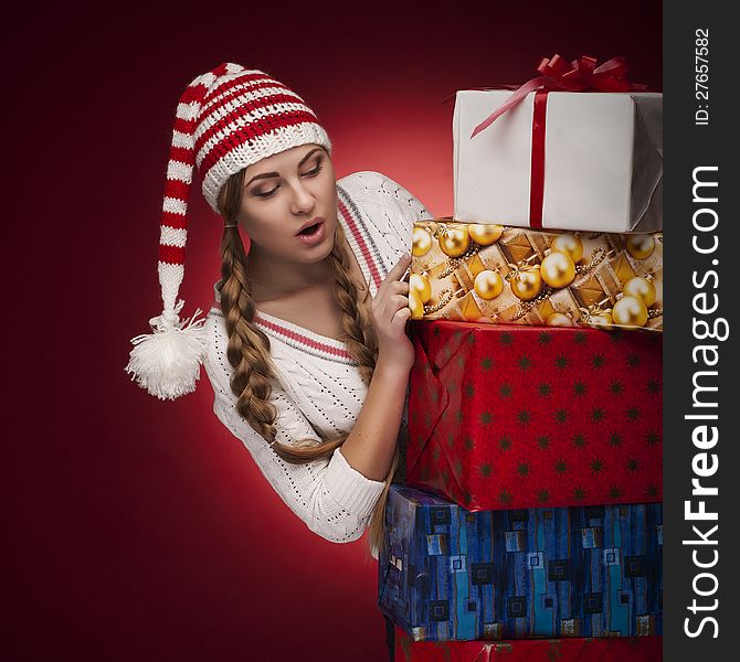 Studio shoot of woman with Santa hat with presents isolated. Studio shoot of woman with Santa hat with presents isolated