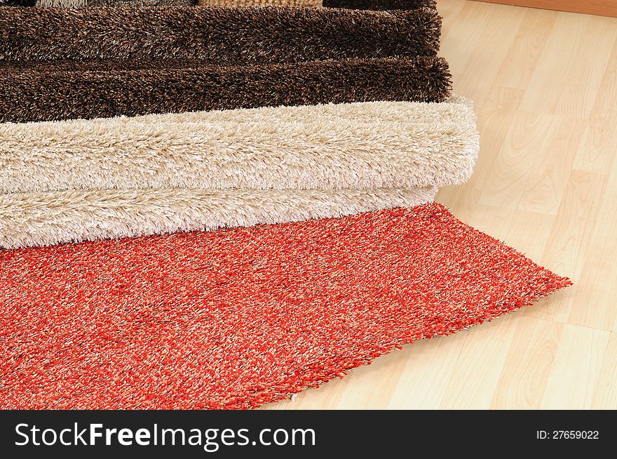 Variety of different rugs on wooden floor. Variety of different rugs on wooden floor.