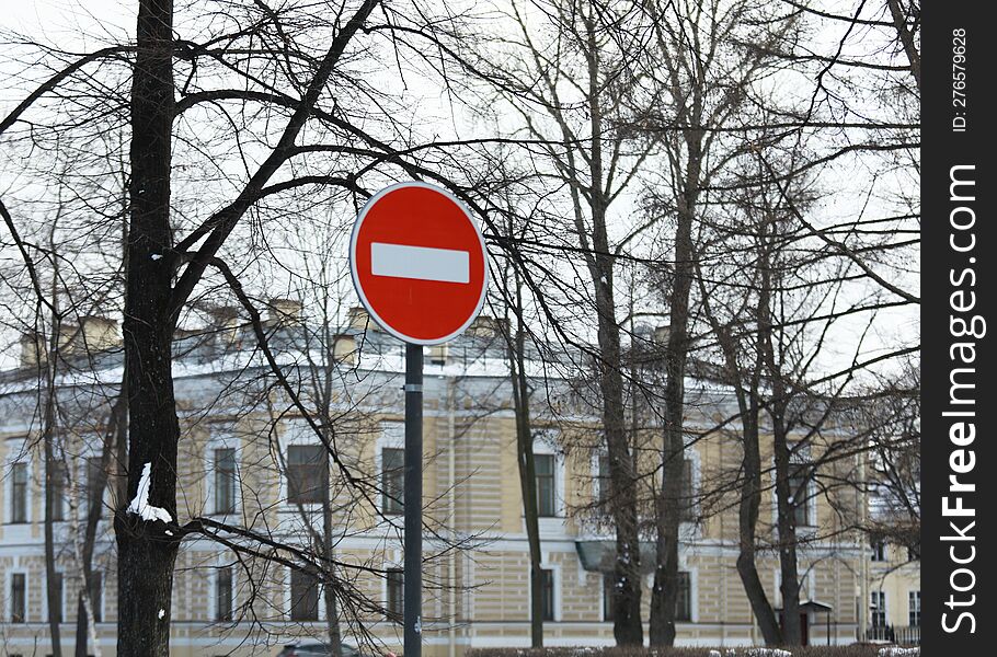 road sign meaning traffic is prohibited on the background of the building in winter