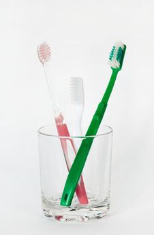 Three Toothbrushes In A Glass Beaker Stock Photography