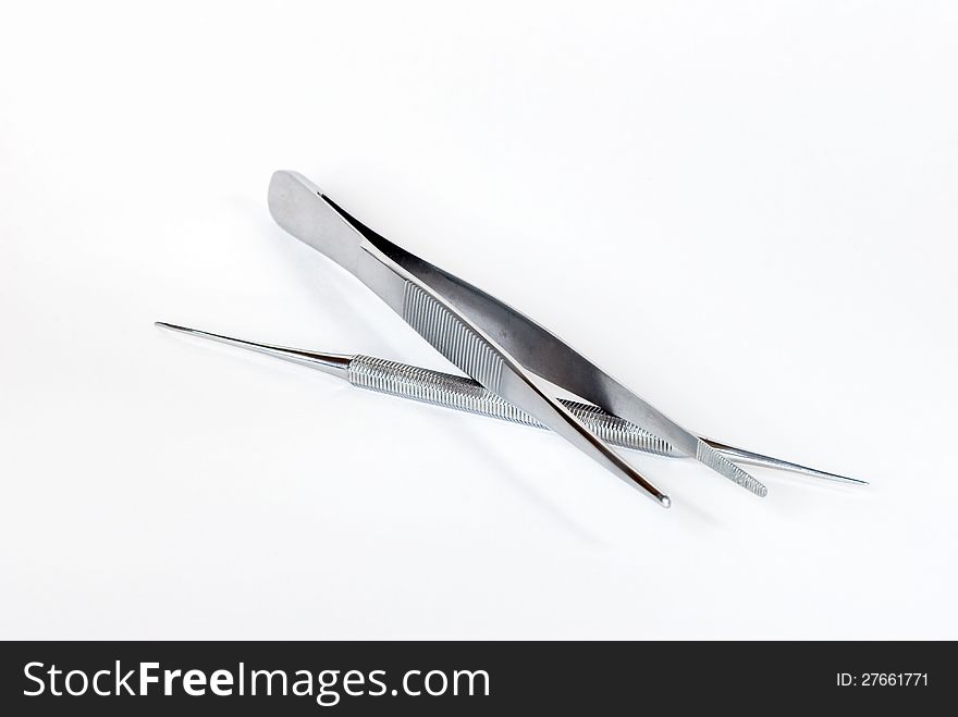 Metal medical tools on a white background