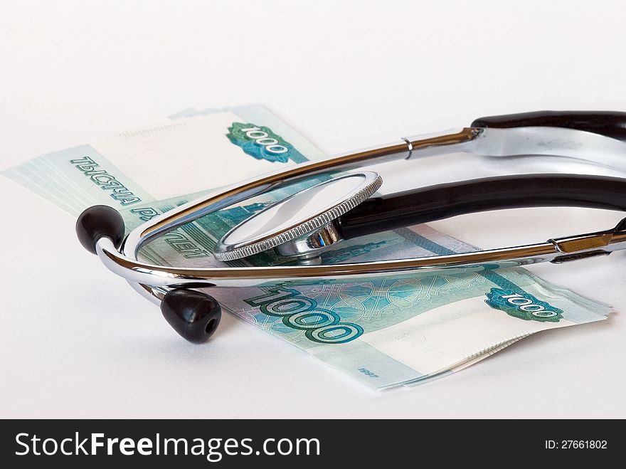 Stethoscope and banknotes on a white background close-up