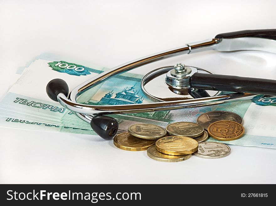 Stethoscope and money on a white background close-up