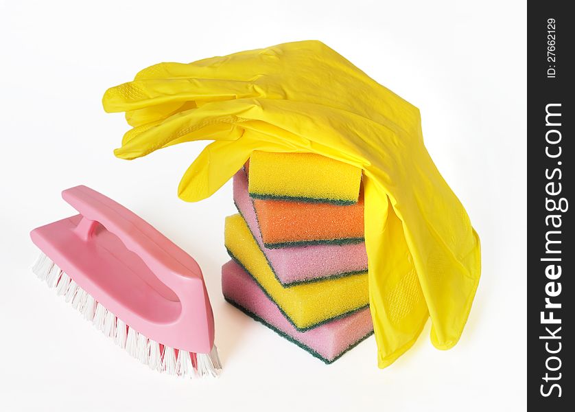 Different colors sponges for washing dishes, brush and rubber gloves on a white background. Different colors sponges for washing dishes, brush and rubber gloves on a white background