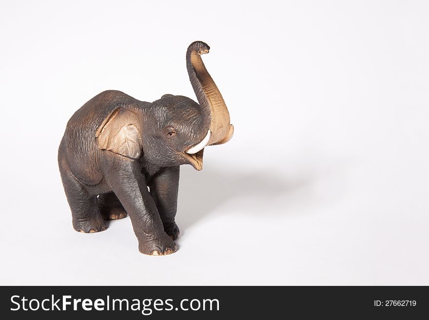 Figurine gray elephant with a raised trunk