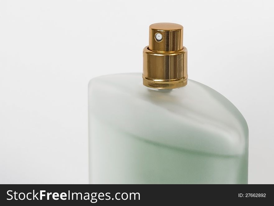 Green vial of eau de toilette on a white background