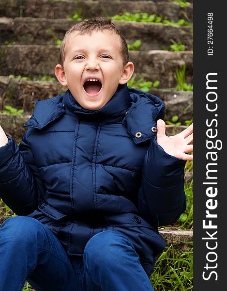 Little cute boy screaming outdoors