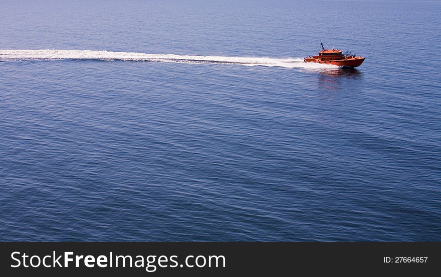 A red speed boat in the middle of the sea. A red speed boat in the middle of the sea