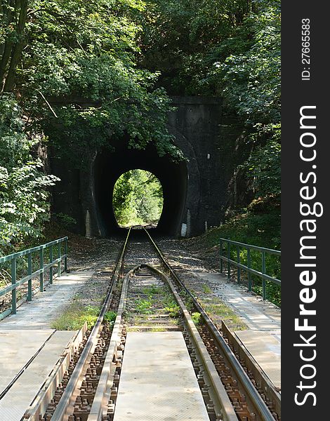 Train line in the Bakony (Hungary). Sunny light at the end of the tunnel.