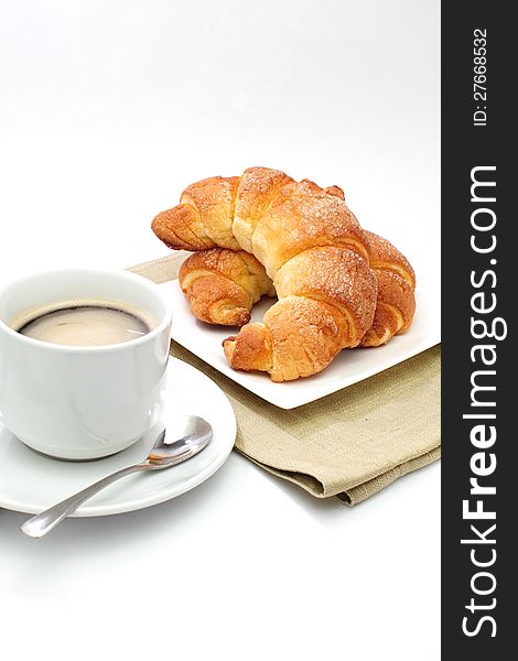 Croissants ans a cup of coffee  in white background