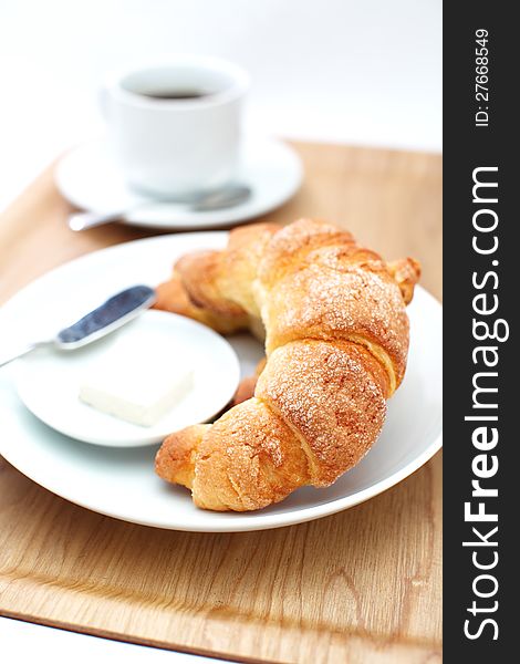 Croissants ans a cup of coffee in white background