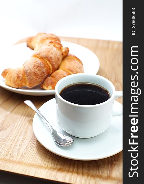 Croissants ans a cup of coffee  in white background