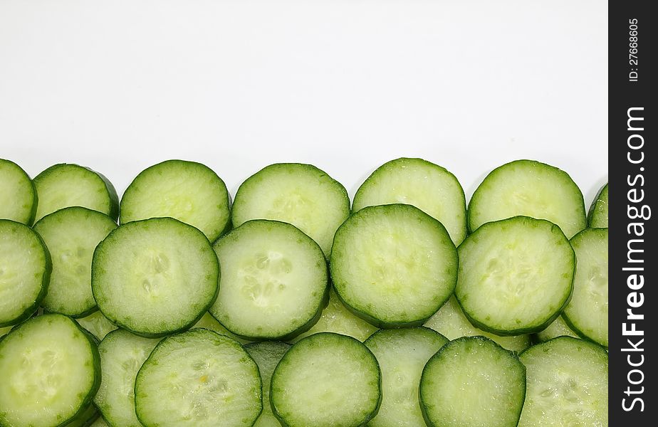 Cut green cucumber texture close up half frame