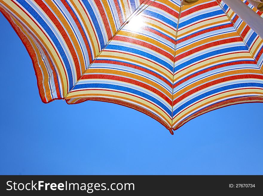 Blue sky and beach umbrella