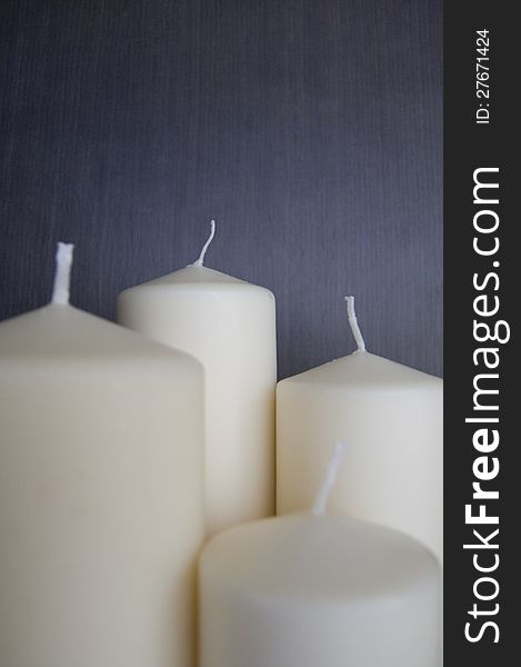 White candles over a dark background