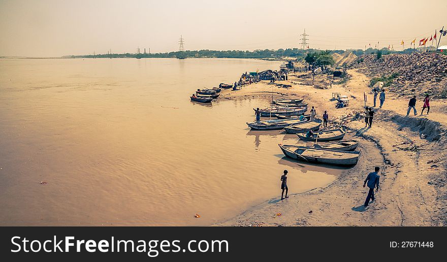 Indian fisherman collecting fish from his boat in river ganga city kanpur. Indian fisherman collecting fish from his boat in river ganga city kanpur