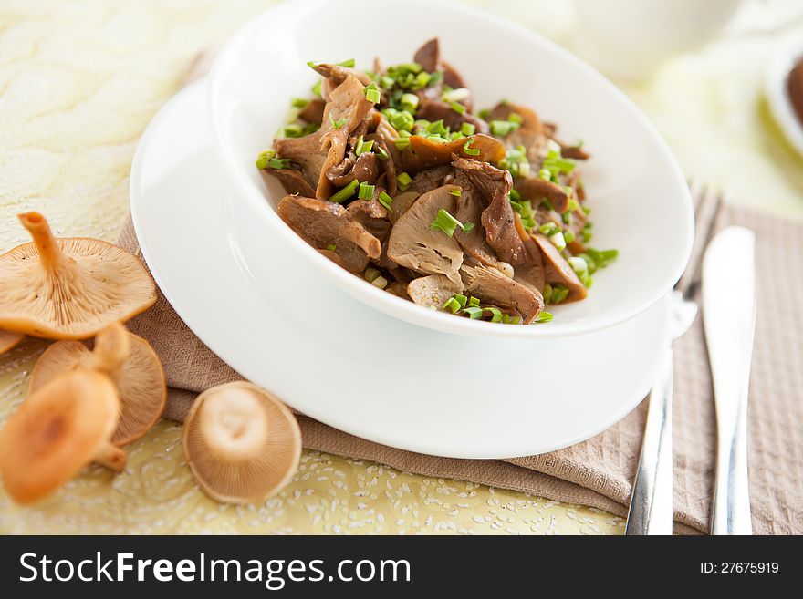 Cooked chanterelles with green onions