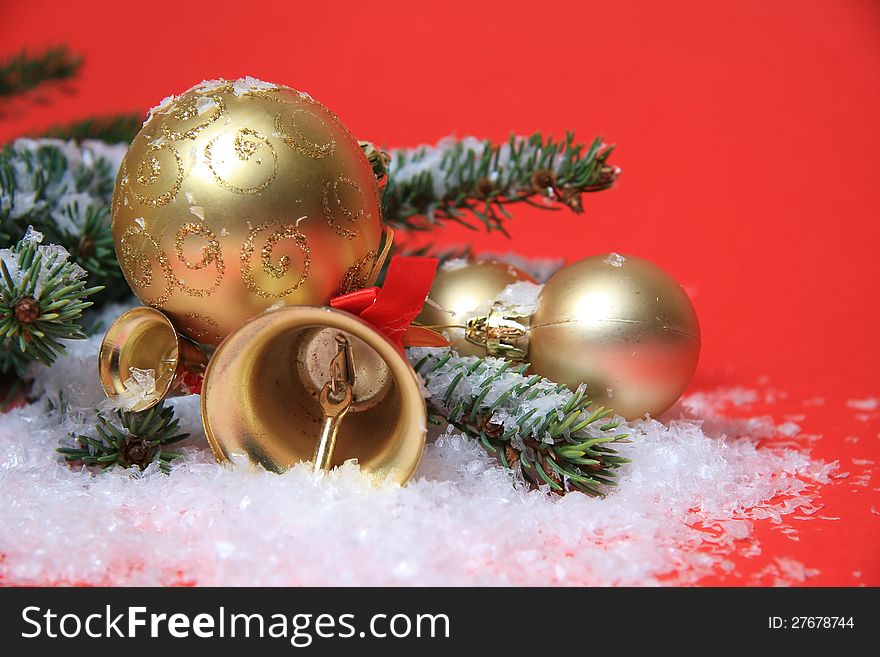 Gold christmas bells and balls on snow. Gold christmas bells and balls on snow