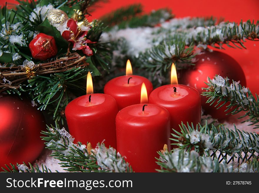 Four red advent candles with fir twigs and ornaments. Four red advent candles with fir twigs and ornaments