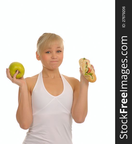 Slim woman choosing between apple and hamburger